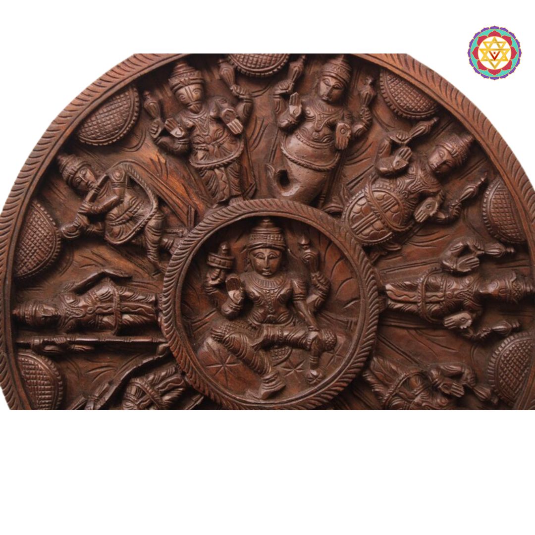 Wooden relief sculpture with intricate carvings of figures and scenes, featuring a central figure. Full front view of round carved Dasavatara panel.