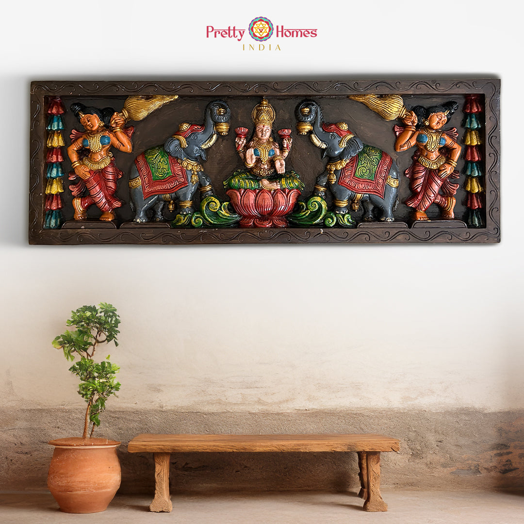 Carved wooden Gajalakshmi wall panel with angels and elephants