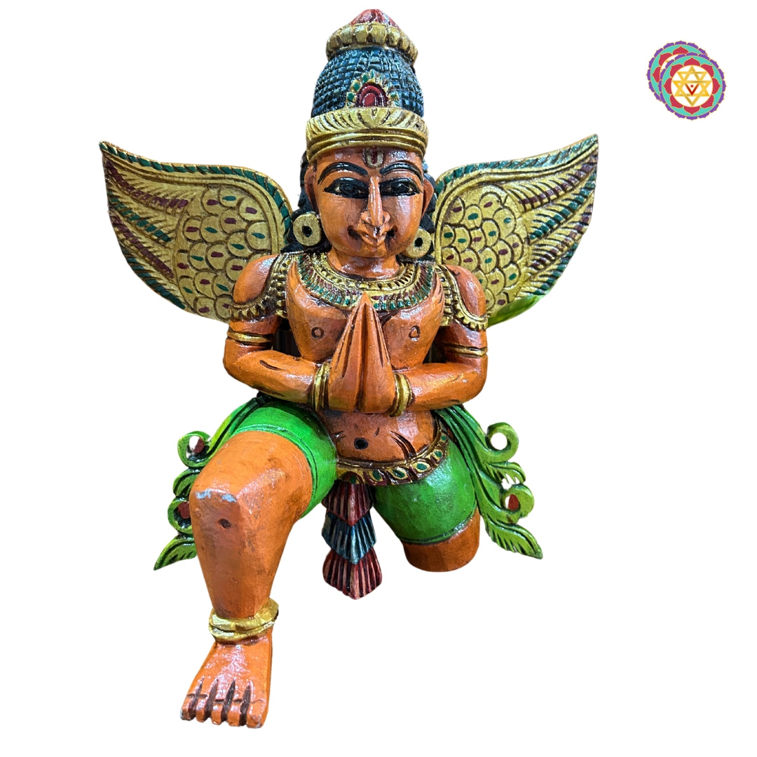 Front view of Garuda wooden statue seated in meditation — finely carved detailing, antique gold polish finish