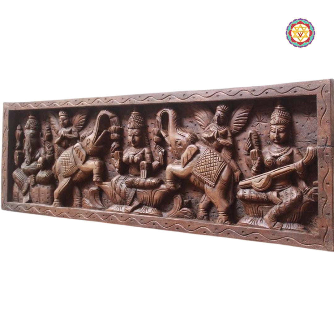 Side angle view of hand-carved Ganesha on wooden panel