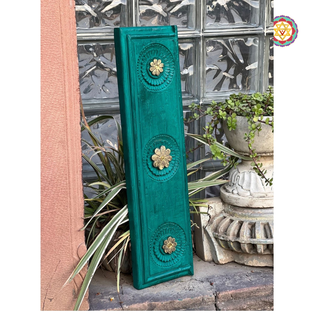 Side view of green mango wood carved panel with floral brass inlay