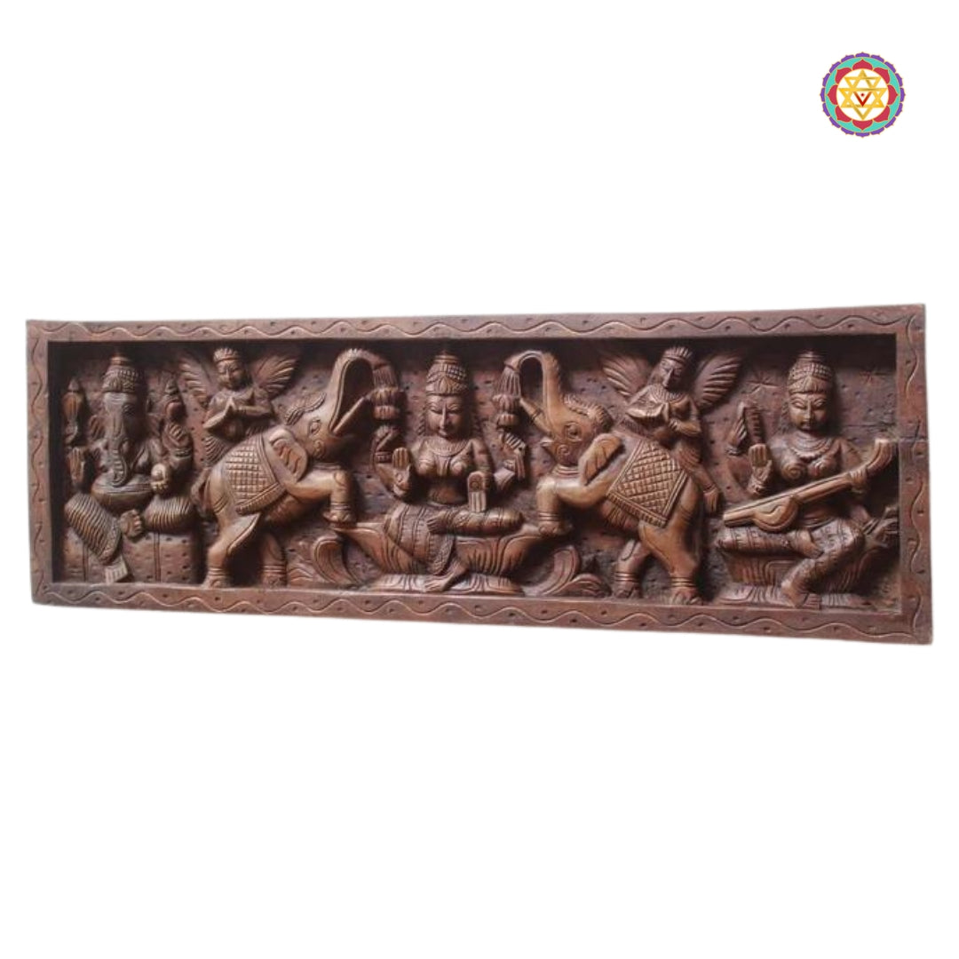 Close-up of Gajalakshmi in center of wooden decorative panel