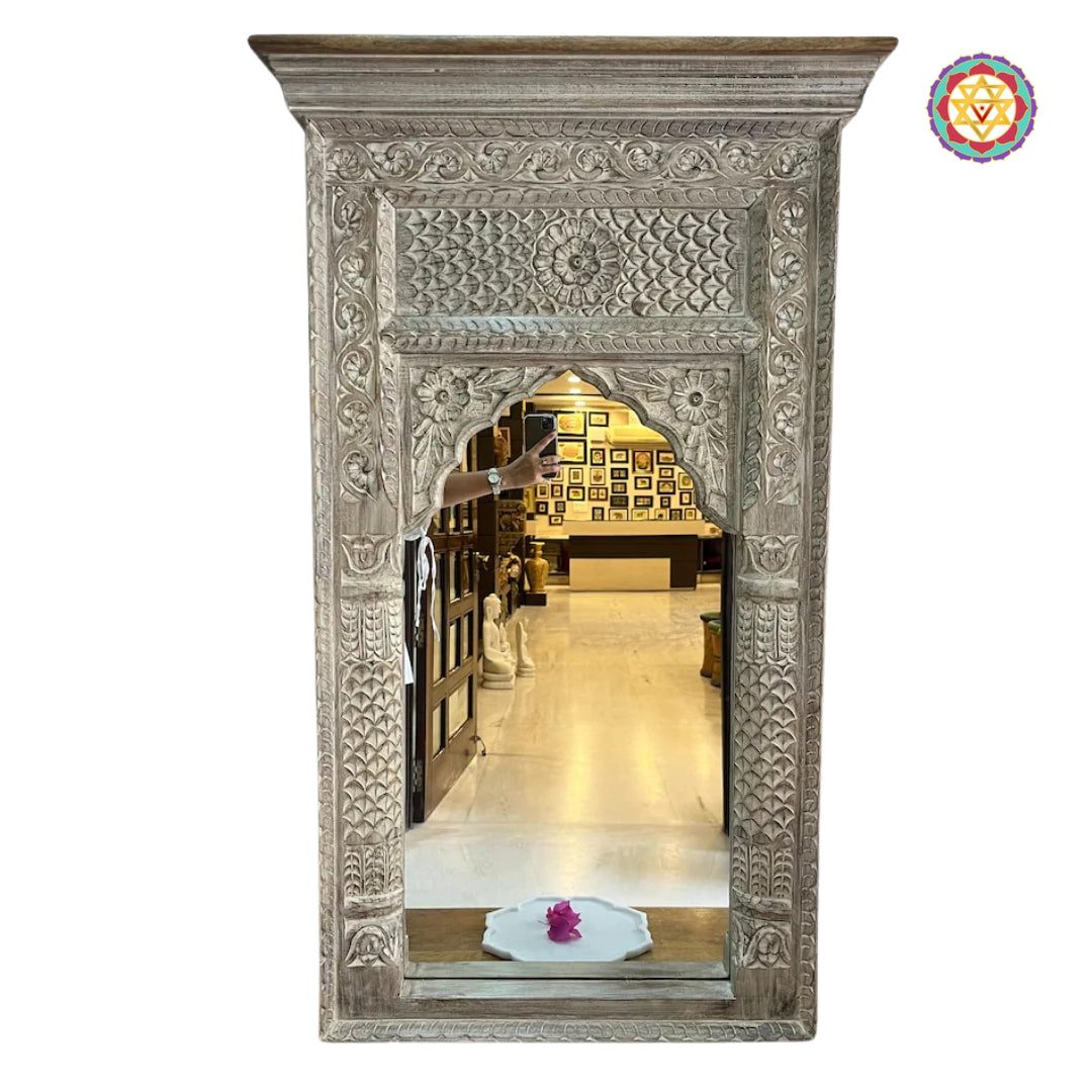“Jharokha mirror in distressed turquoise finish with ornate wooden carvings.”