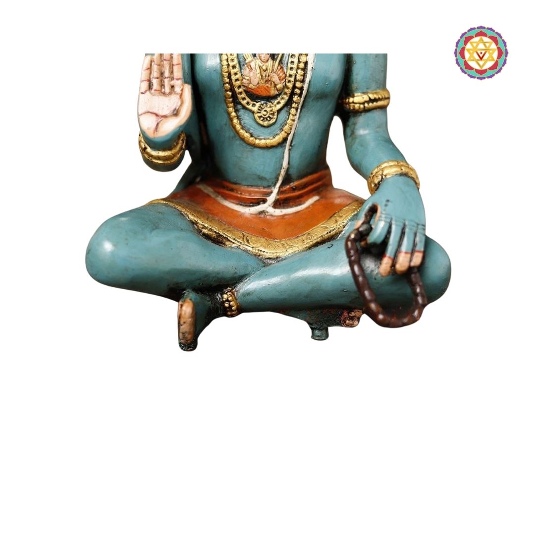 angled shot of Hanuman statue on decorative base with bell embellishments