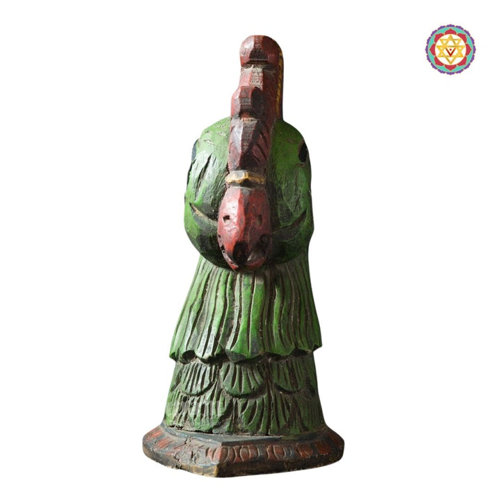 side view of annapakshi carved wood table decor in natural finish