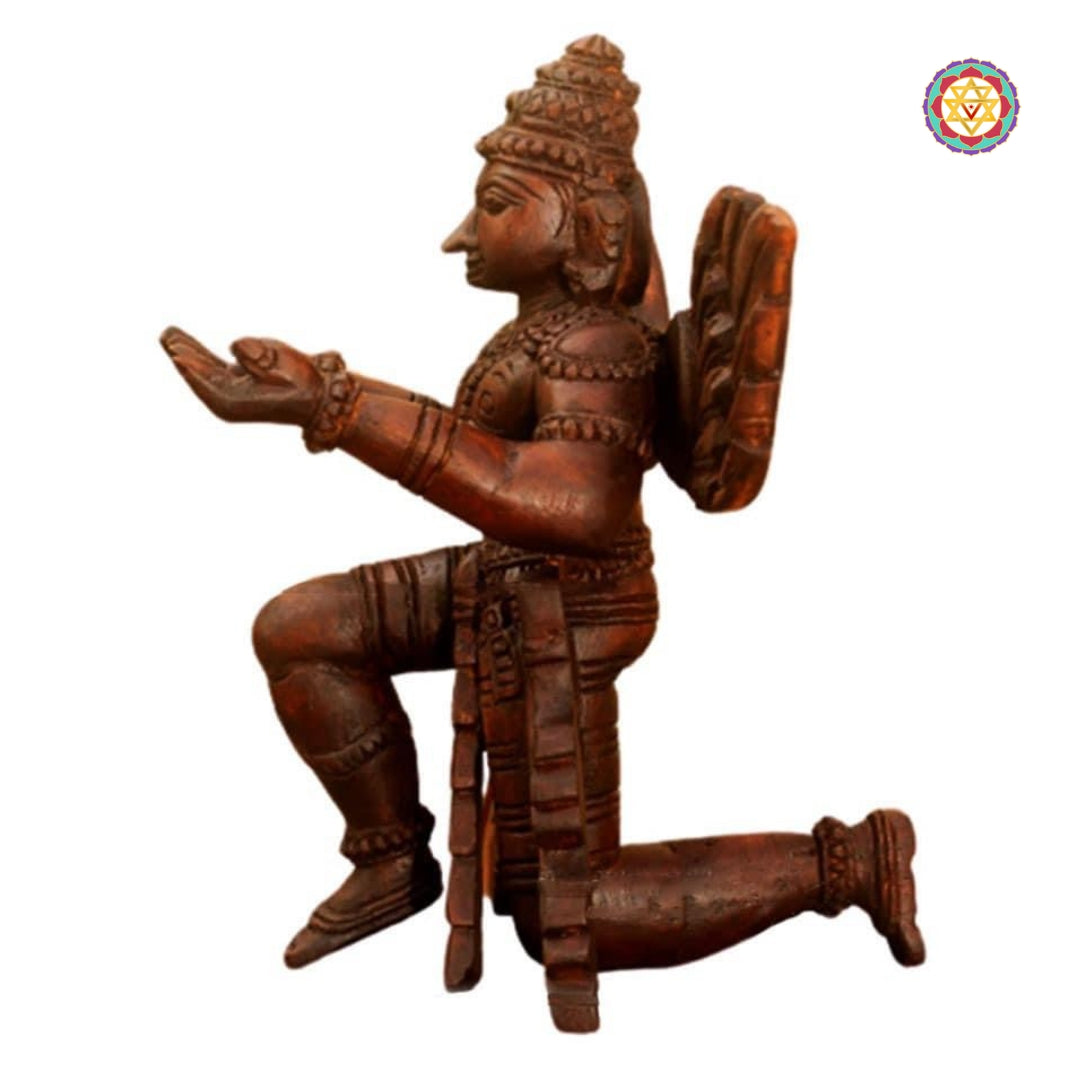 Side profile of Garuda meditating wooden sculpture — antique brown finish, hand-carved feathers and robe pattern visible