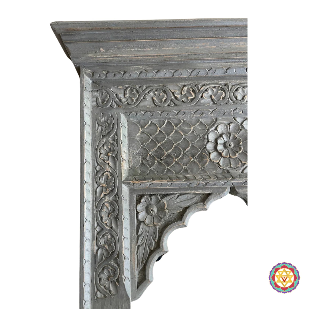Close-up of the floral and geometric carvings on the wooden Jharokha mirror frame.”