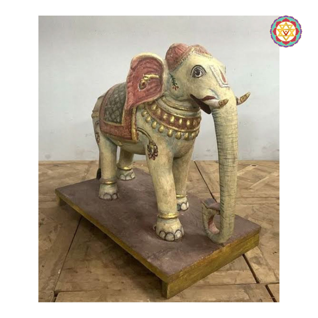 Handcrafted wooden elephant statue featuring ornamental carvings