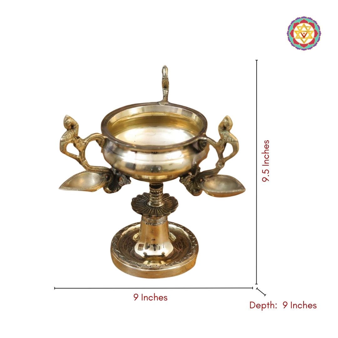 side-angle view of peacock handle diya highlighting carved bird detailing