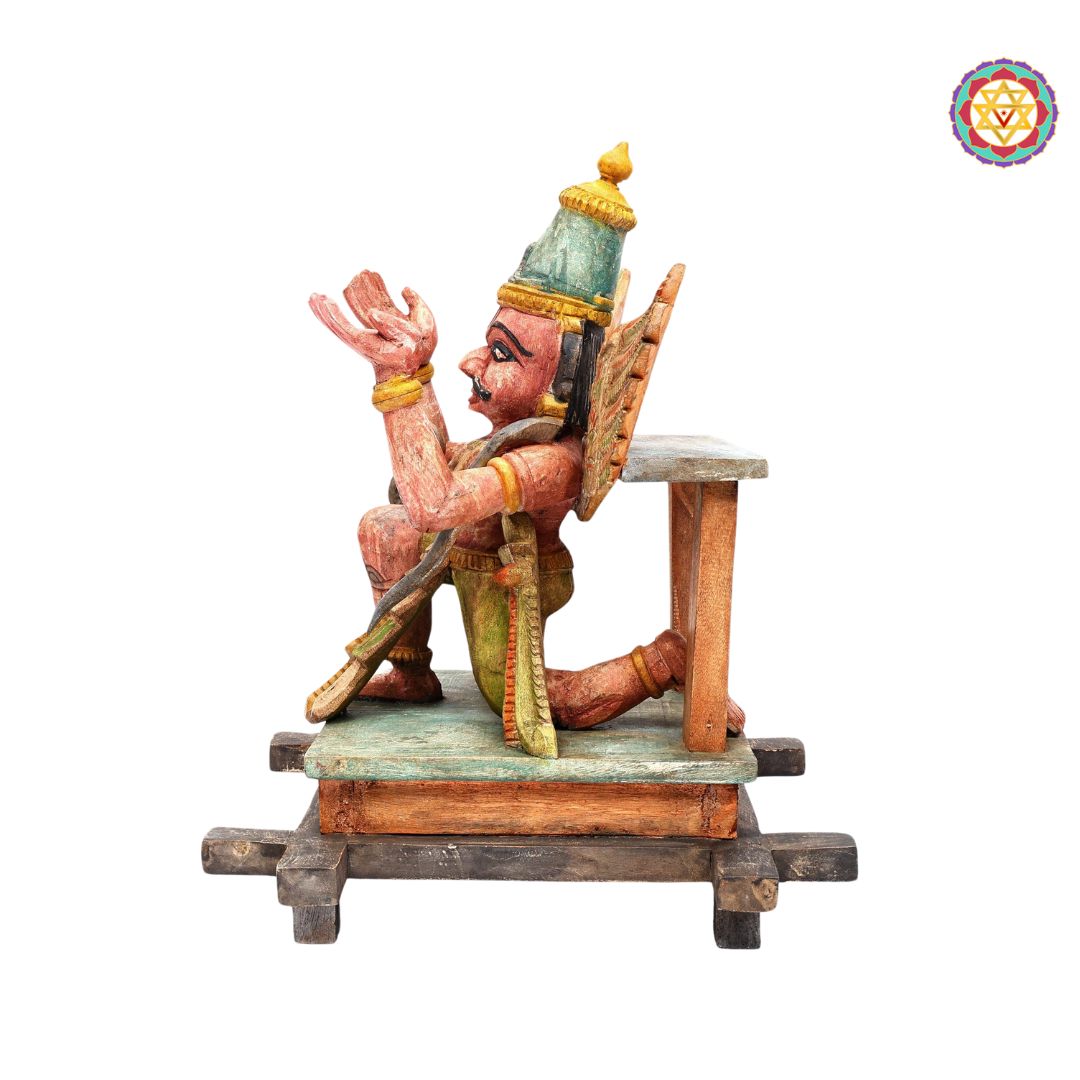 rear angle of intricately carved wooden garuda statue