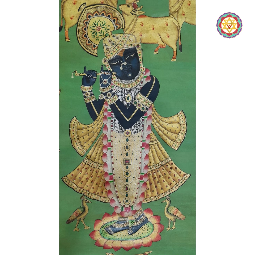 Traditional pichwai cow motifs in symmetrical border surrounding the central Shreenathji figure.