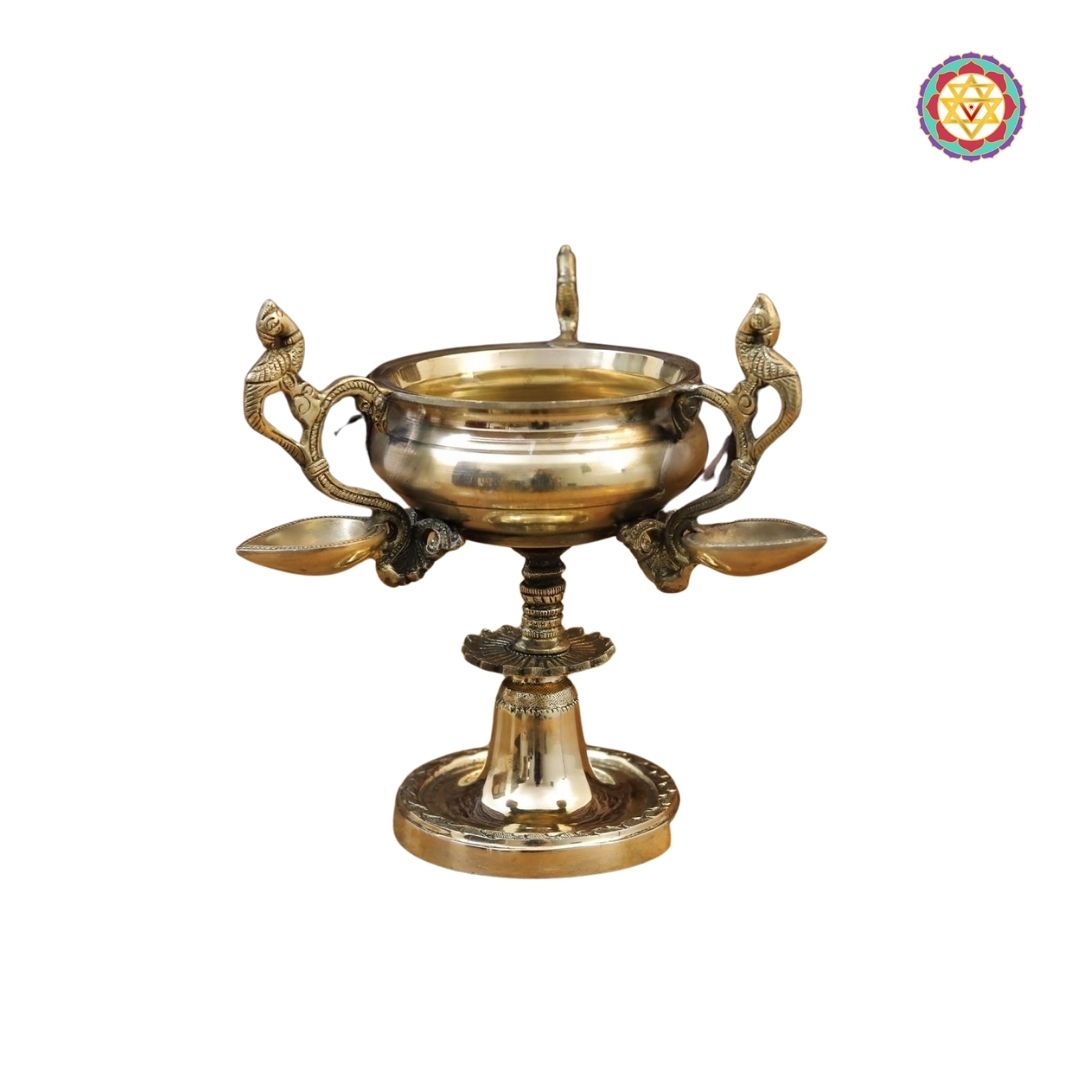 top-angle view of brass peacock diya displaying ornate handle design