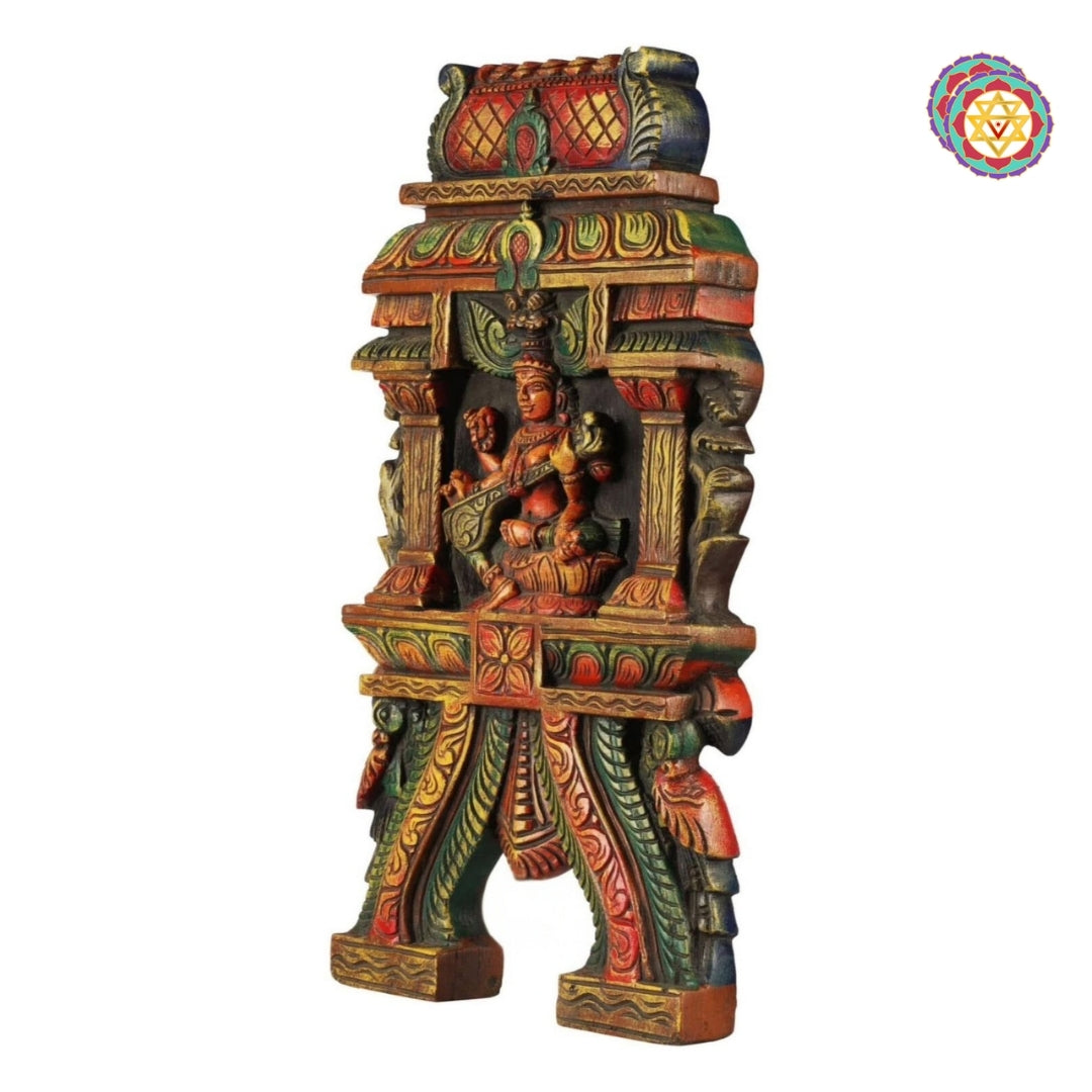 Side view of hand-carved Saraswati wooden wall hanging