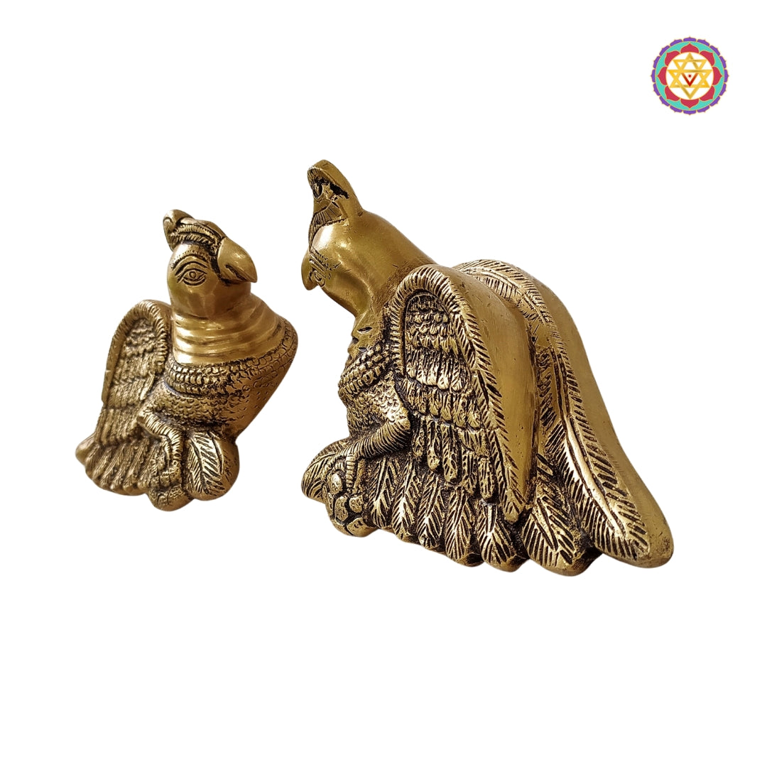 Traditional brass parrot sculptures symbolizing love and joy
