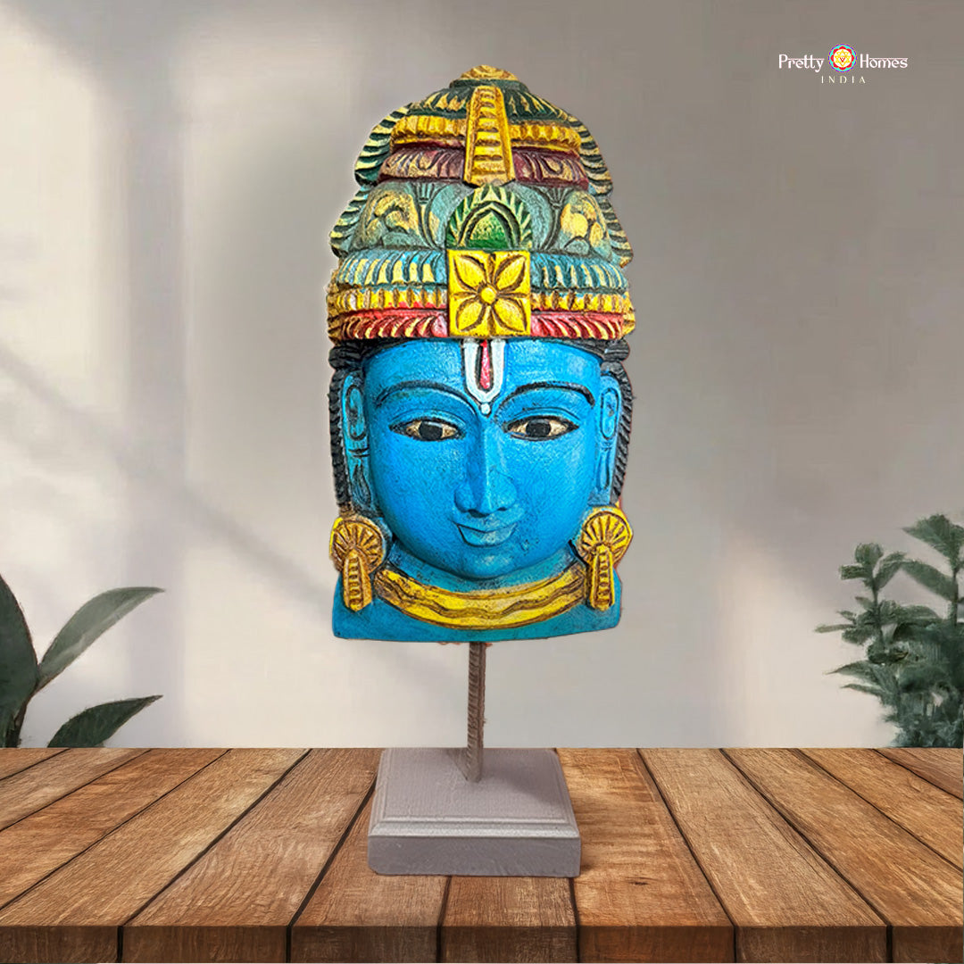Handcarved wooden Vishnu mask displayed on tabletop stand
