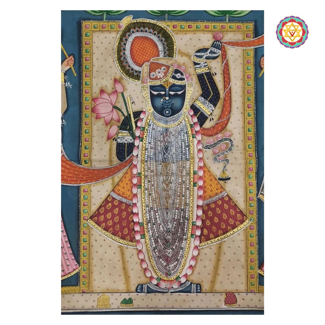 Detail of Shrinathji in hand-painted pichwai, floral border and lotus motifs.