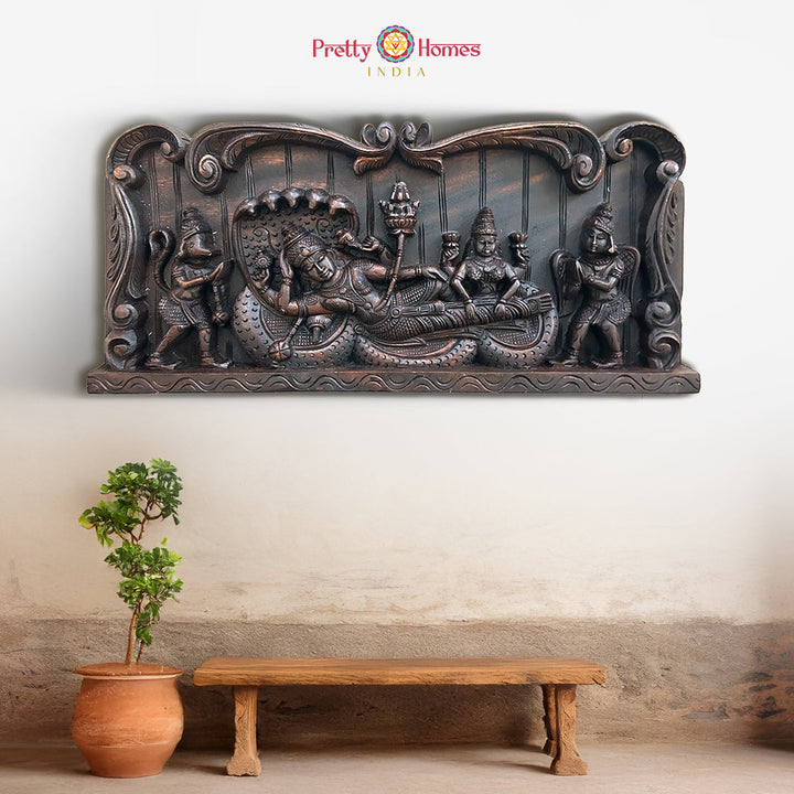 Carved wooden panel of Vishnu in Ananta Shayana with Lakshmi

