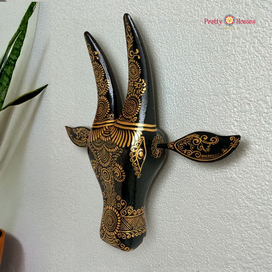 black abstract wood-carved cow head (nandi) wall mount with stylized features and matte finish