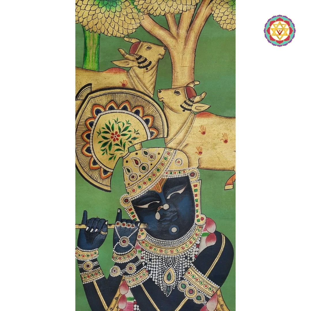 Depiction: A close-up of Lord Krishna playing the flute. His dark blue skin, ornate jewelry, and regal posture are classic traits. Behind him are two cows, and the background shows a stylized tree.