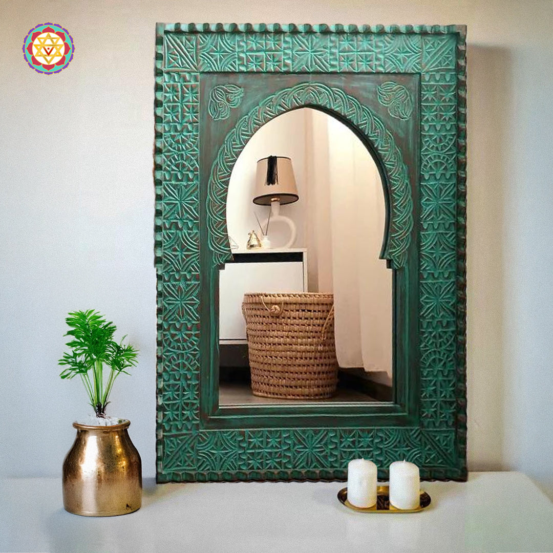 Green wooden Moroccan-style mirror frame on wall