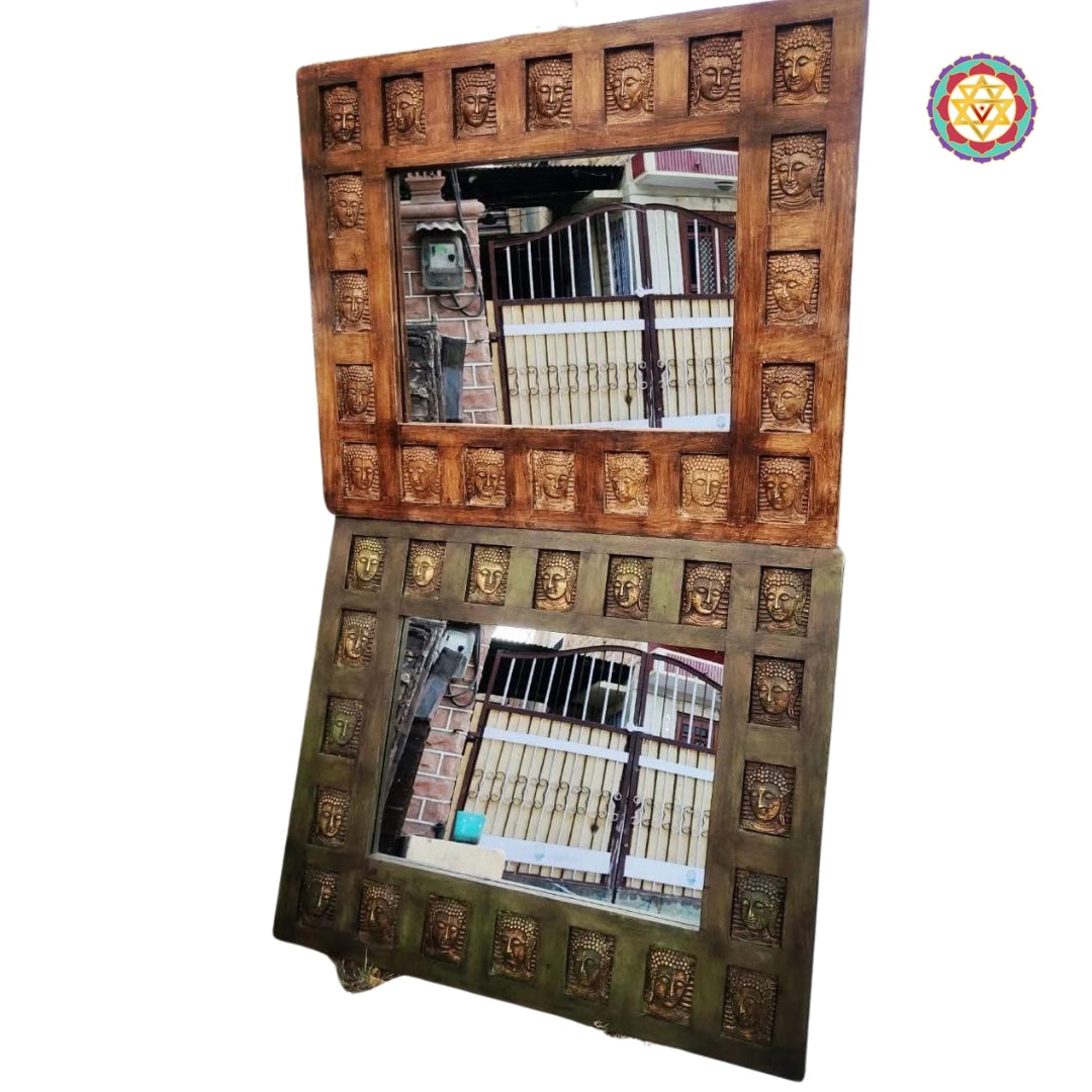 Mirror frame with brass Buddha motifs in natural light