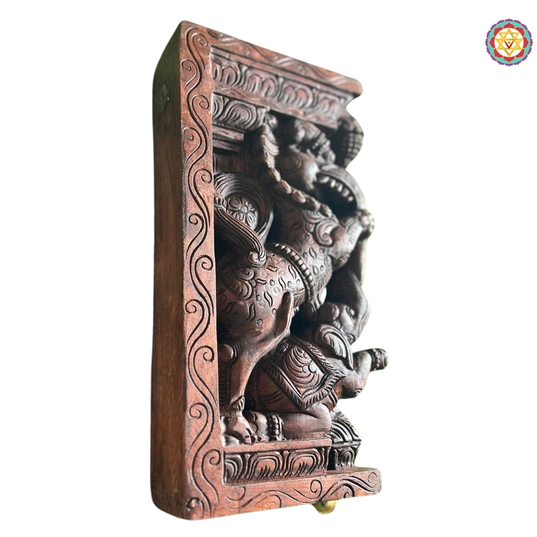 Fine carving detail of wooden Yali wall bracket showing mythological yali and elephant artistry