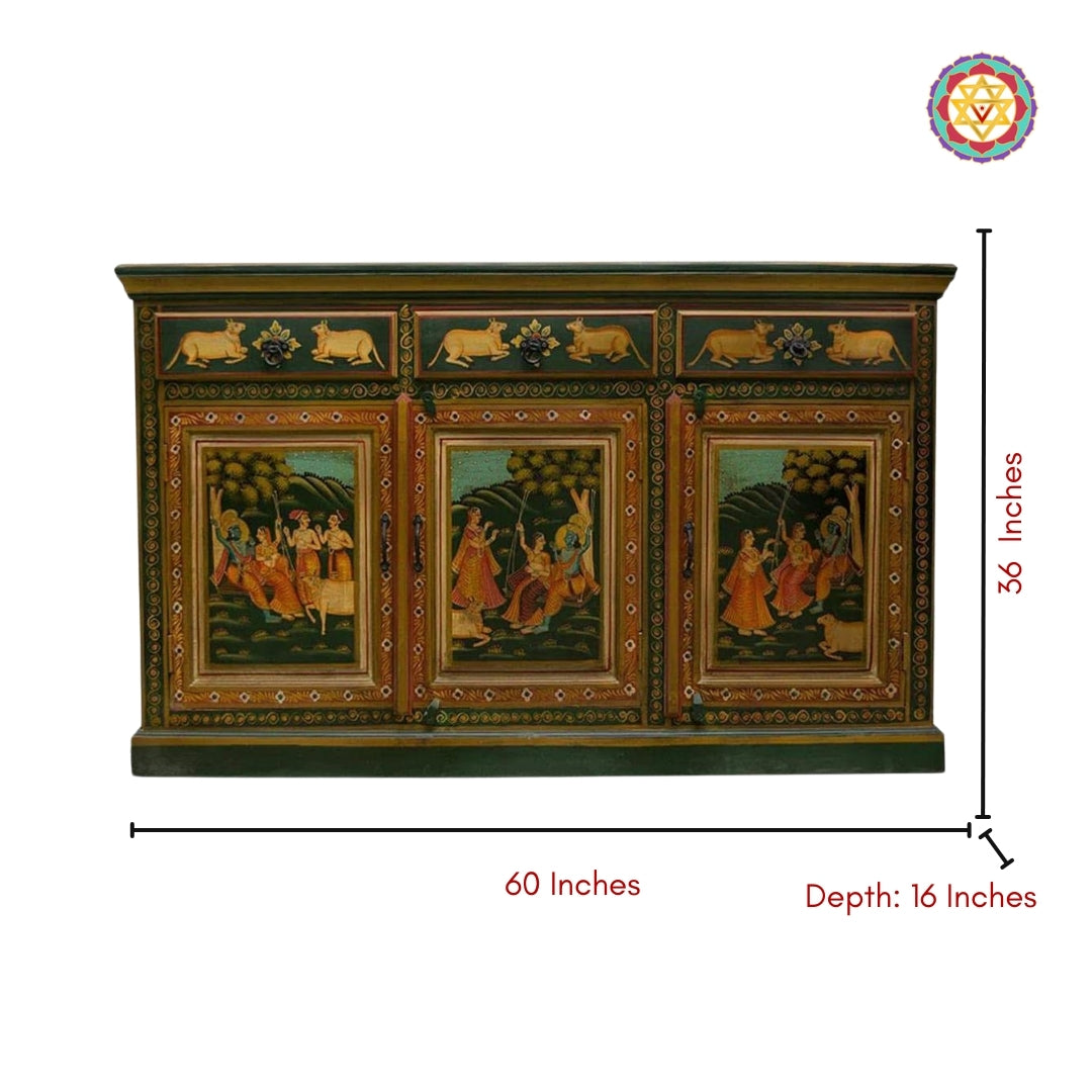 Front view of hand-painted pichwai painting of Rajasthan sideboard with Krishna and gopikas. Sacred pichwai cow motifs on drawers. Cabinet measures 60 inches wide, 36 inches tall, and 16 inches deep.
