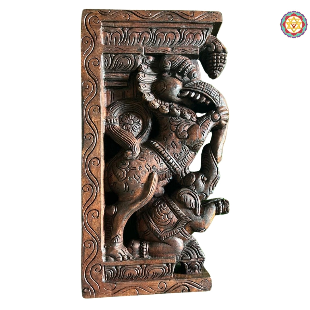 Angled shot of handcrafted Yali wall bracket showing layered carvings and antique polish finish