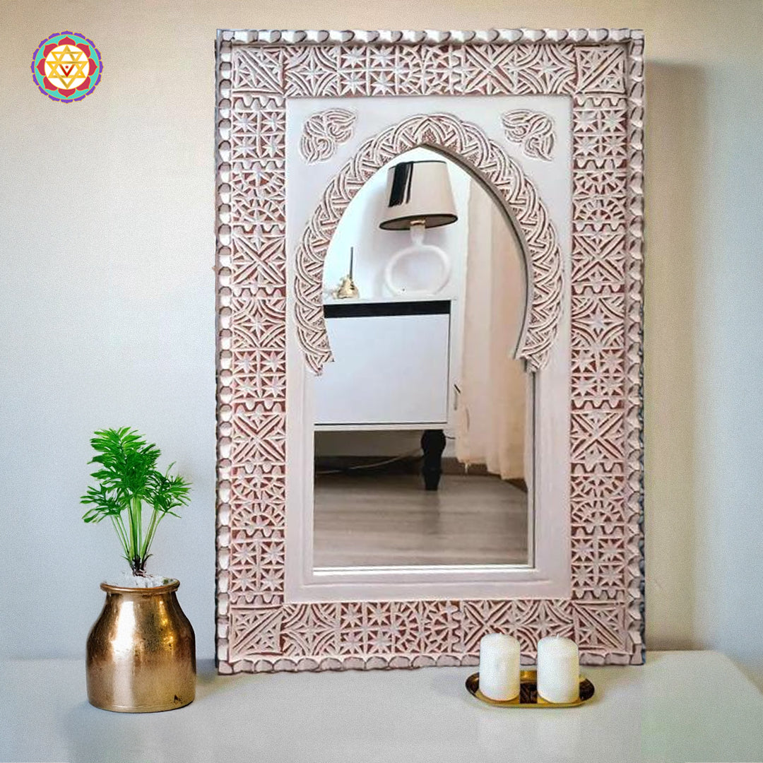 White Moroccan carved mirror frame displayed on wall