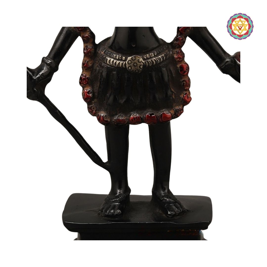 rear angle of Kali sculpture showing carved drapery and textured finish