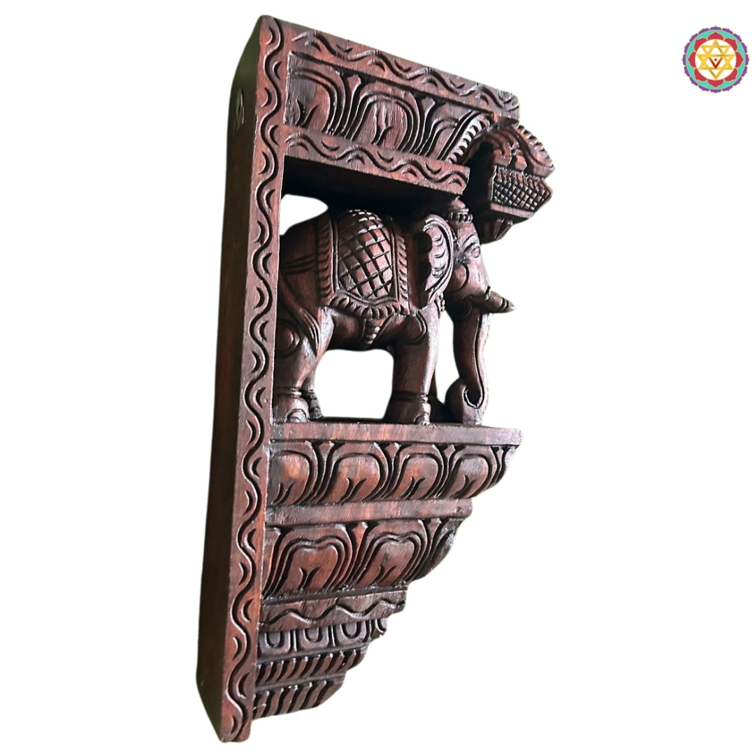 Close-up view of elephant wall bracket showing polished wooden surface and floral patterns