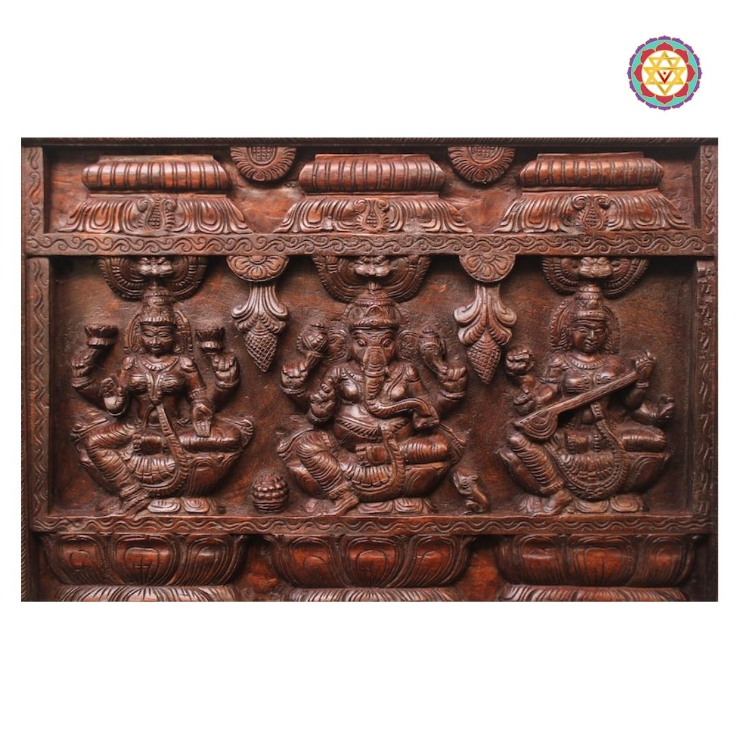ganesha lakshmi saraswati panel close up showing detailed carving and divine trio