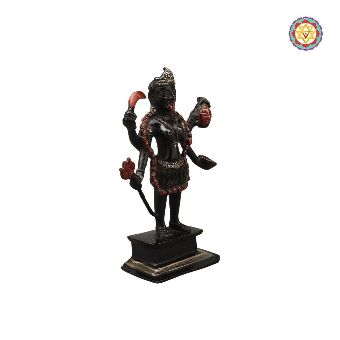 side view of Kali statue highlighting raised arms and ornate weapon detailing