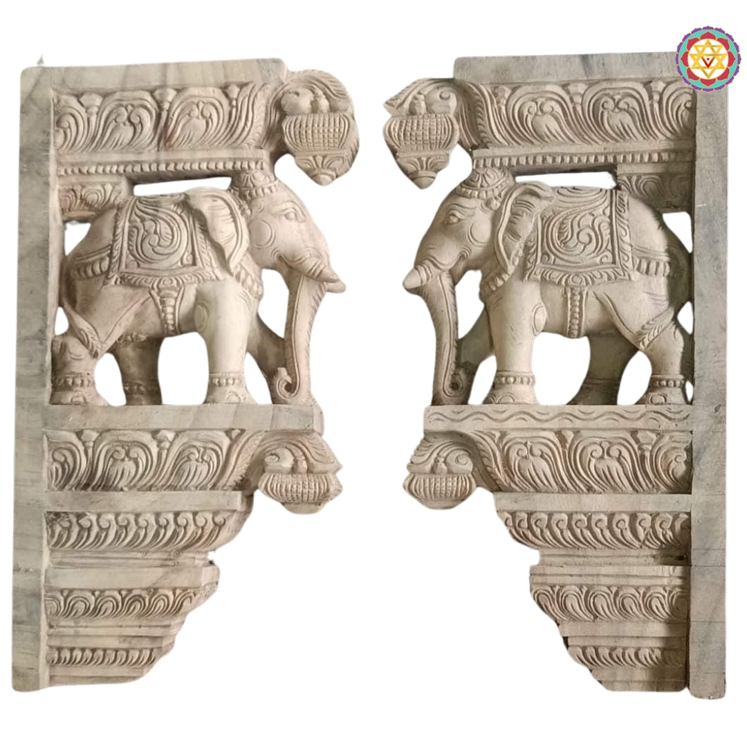 Side profile of wooden elephant wall bracket showing intricate carvings and antique patina finish