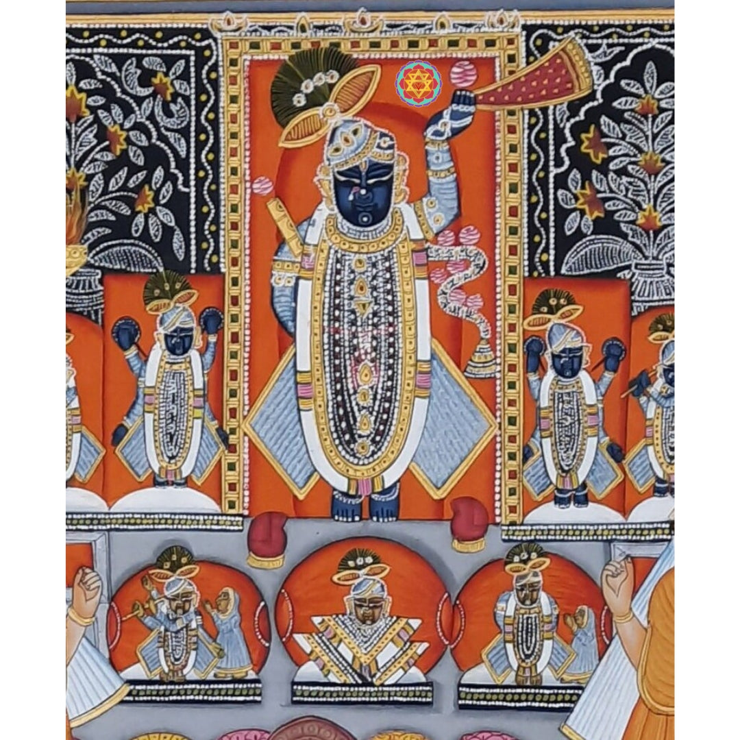 Pichwai Shrinathji panel with dark blue deity, ornate jewelry, attendants and orange shrine background