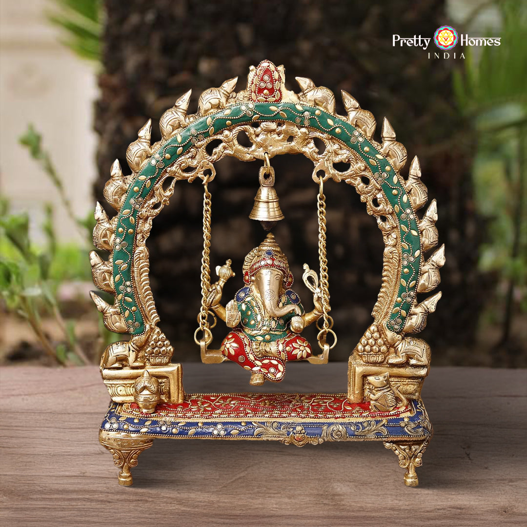 brass Ganesh jhula idol seated on swing with bell and stone detailing