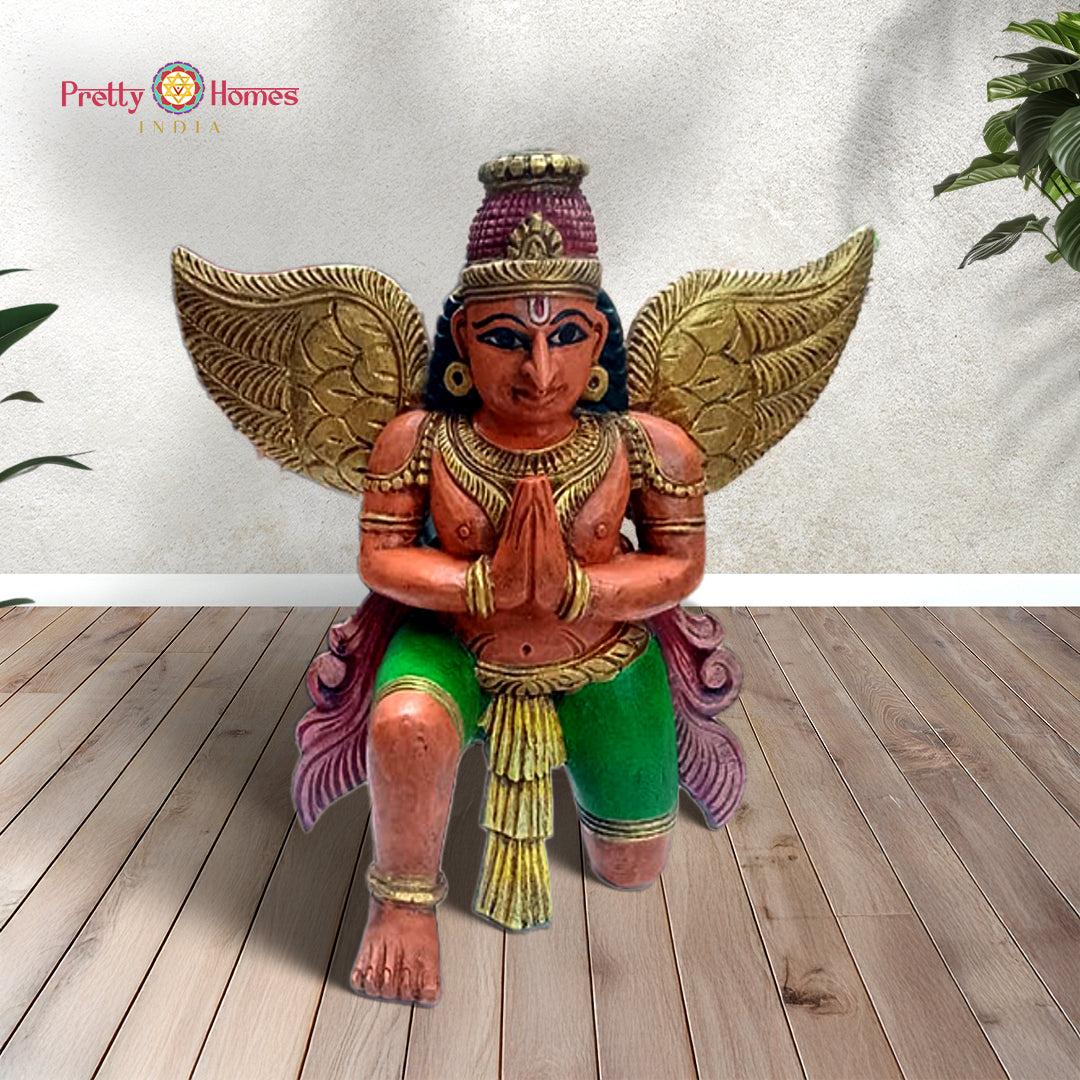 Hand-carved wooden Garuda sculpture in meditation pose — antique gold and brown finish, sacred Hindu bird deity statue for temple decor