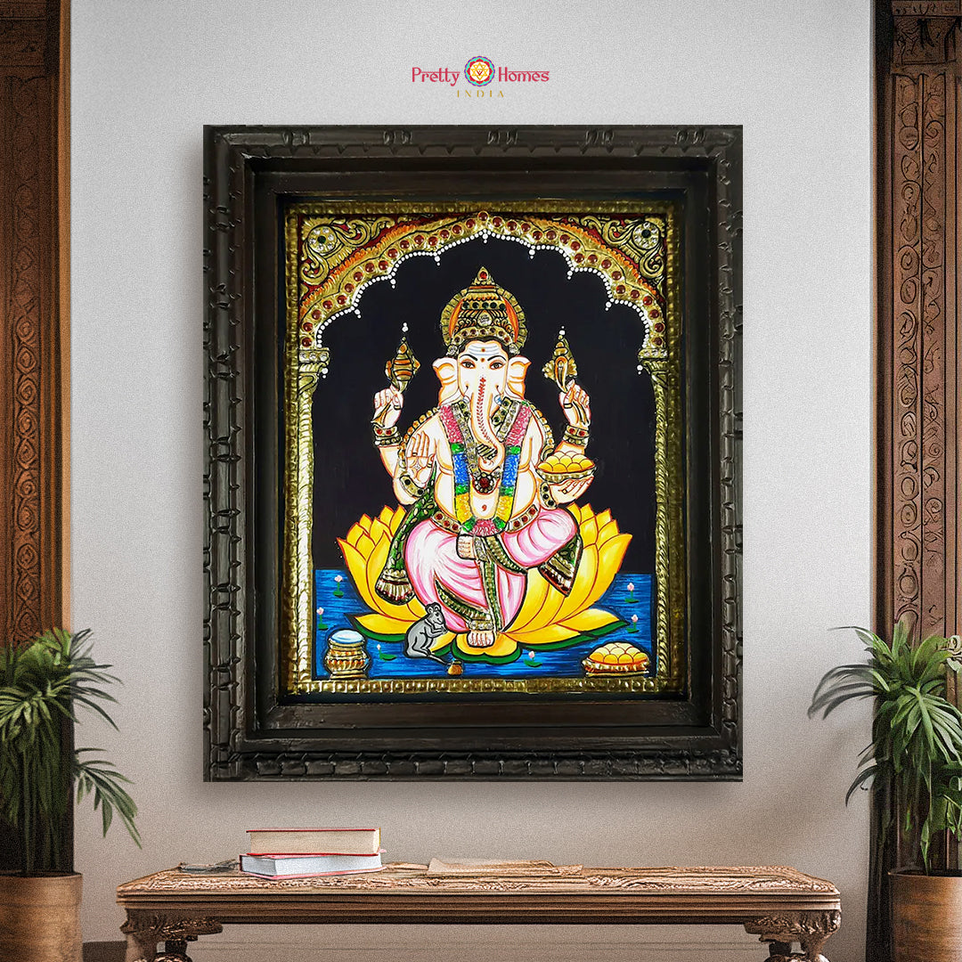Framed Lord Ganesha Tanjore painting with gold foil, displayed on wall with traditional decor