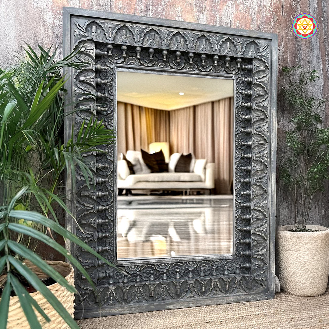 Rustic white carved wooden mirror frame in a corner setup