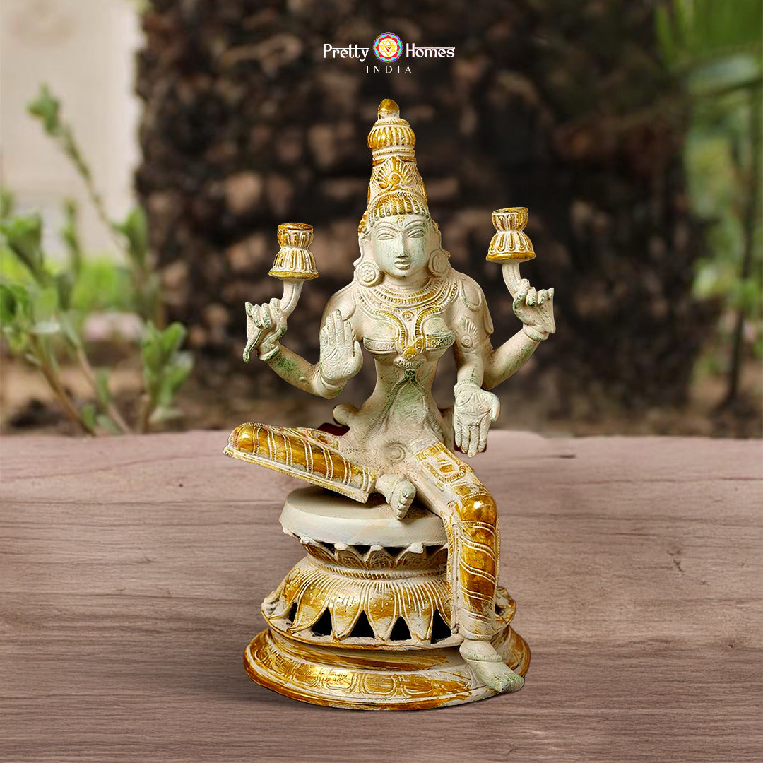 brass Lakshmi statue with white and gold finish symbolizing prosperity
