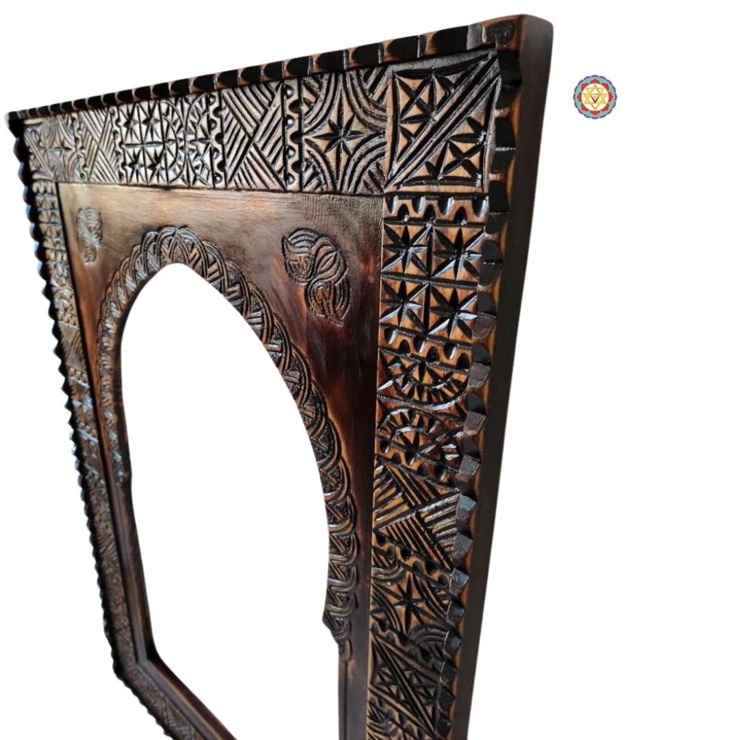 Upper arch close-up of hand-carved wooden frame