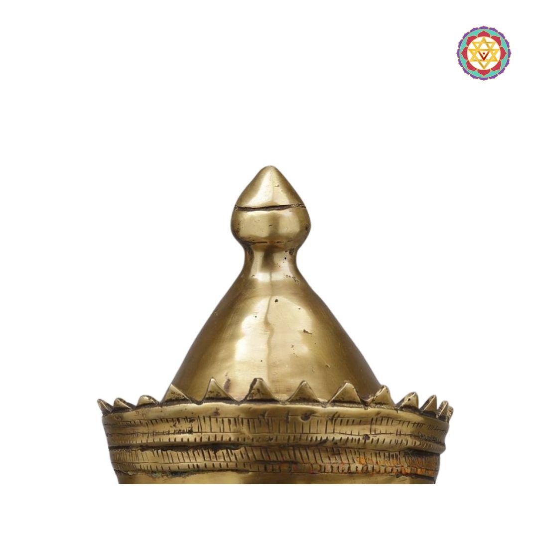 angled view of brass mukhalingam head emphasizing divine expression