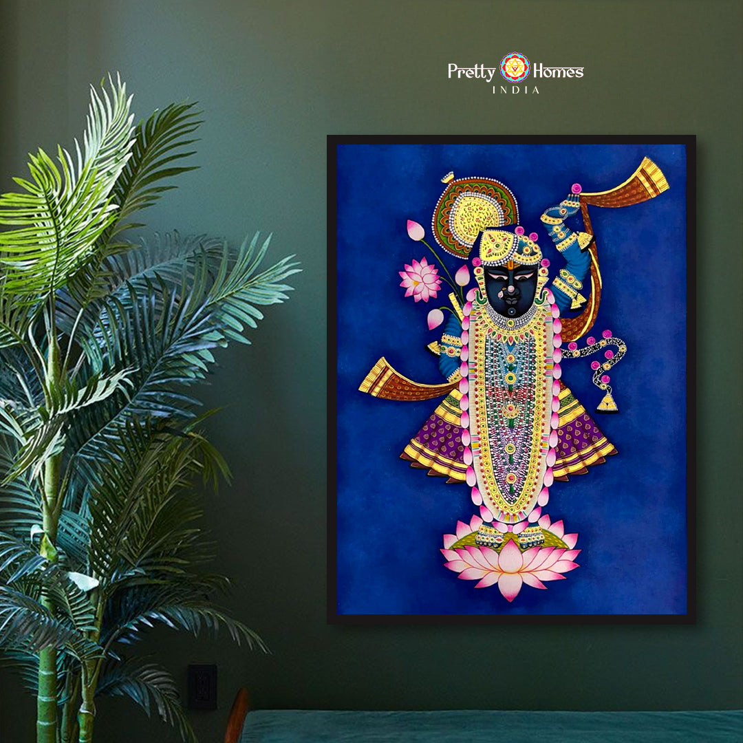 Hand-painted pichwai of Shreenathji standing on lotus, richly adorned, displayed in spiritual home setting.