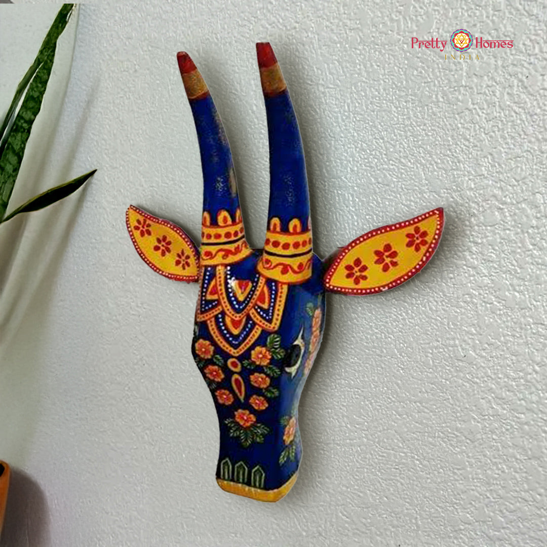 wood-carved blue floral nandi cow head wall decor, hand-painted with floral motifs on polished wood