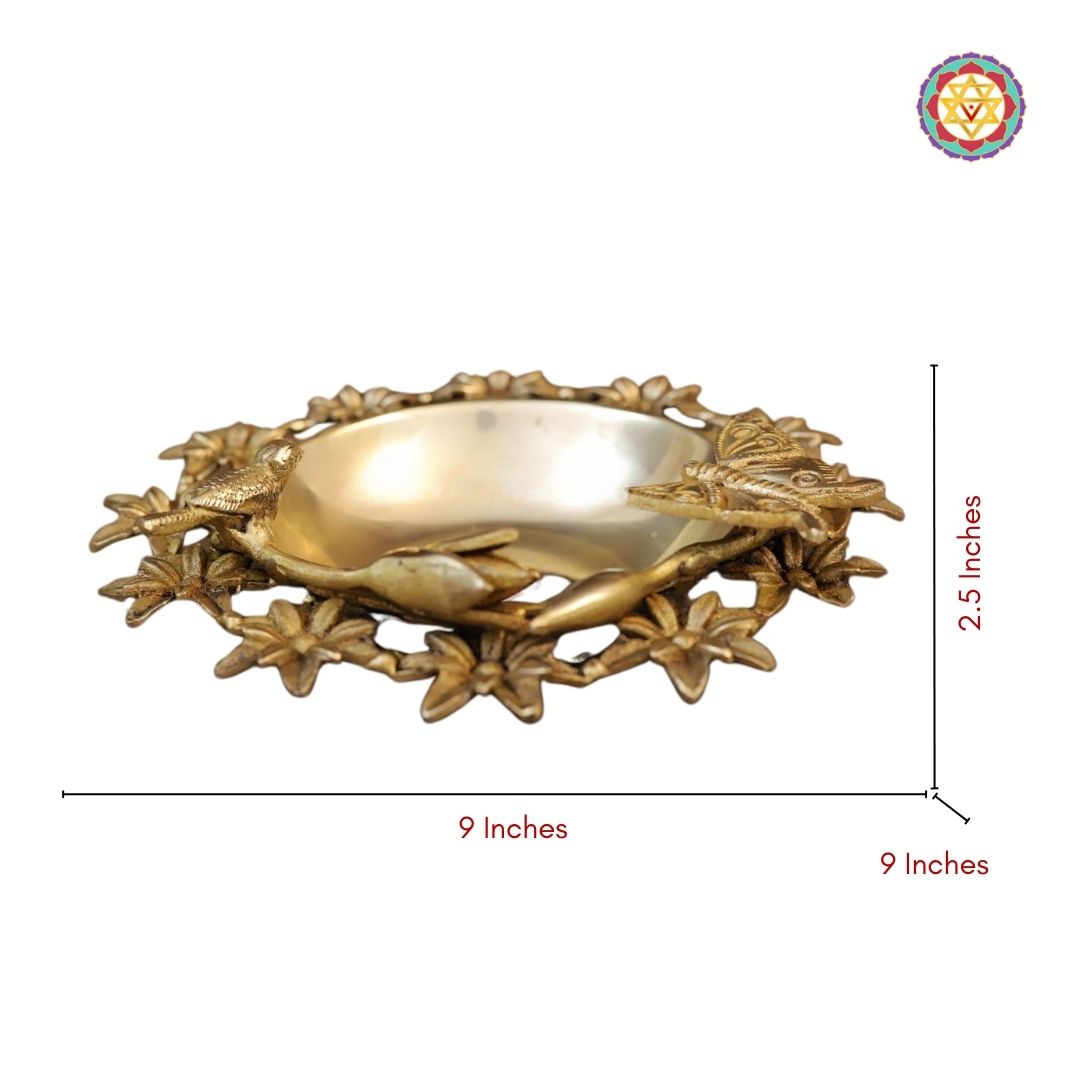 full view of brass floral uruli arranged with floating petals for festive decor