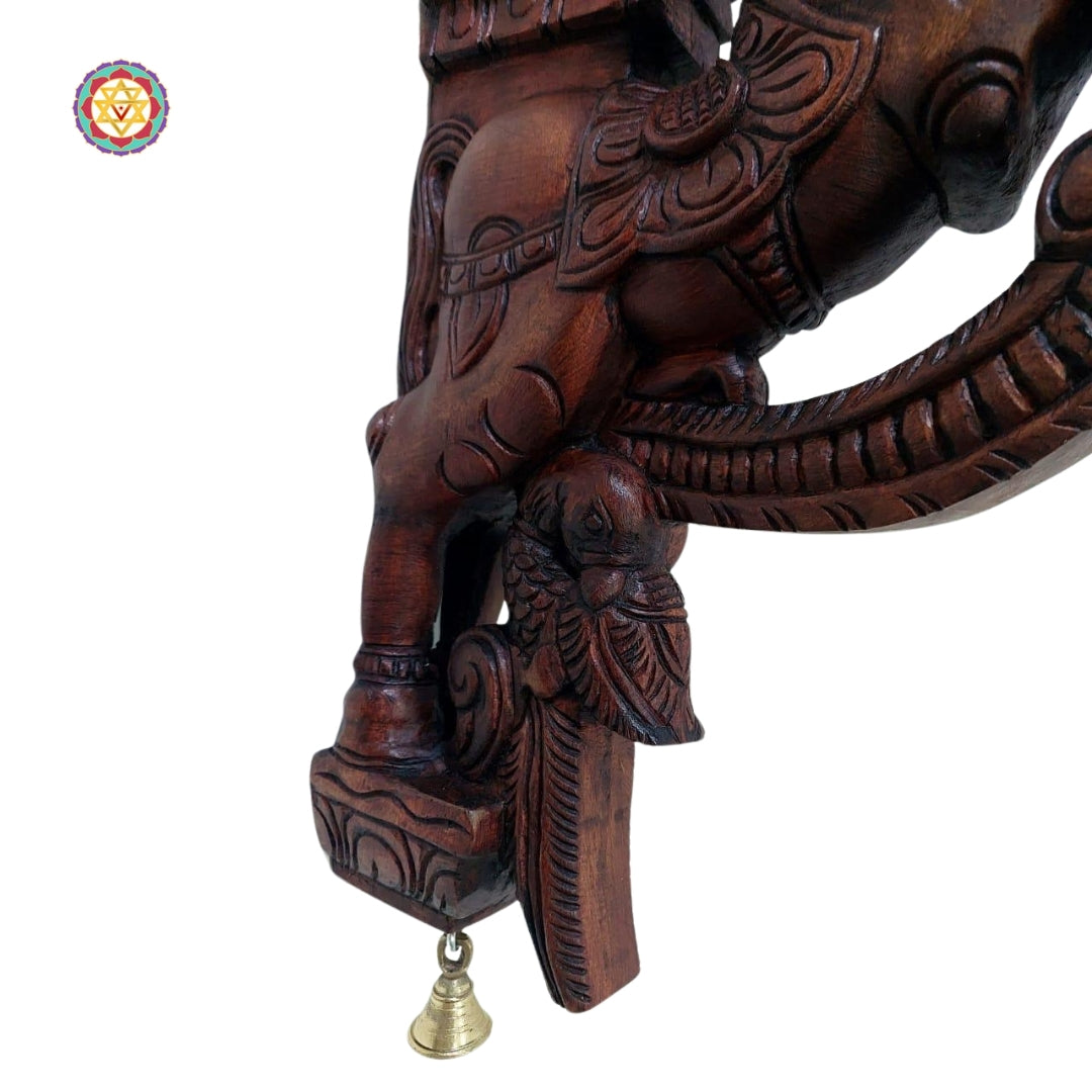 Full view of horse wall brackets showing rich carvings with symmetrical floral composition