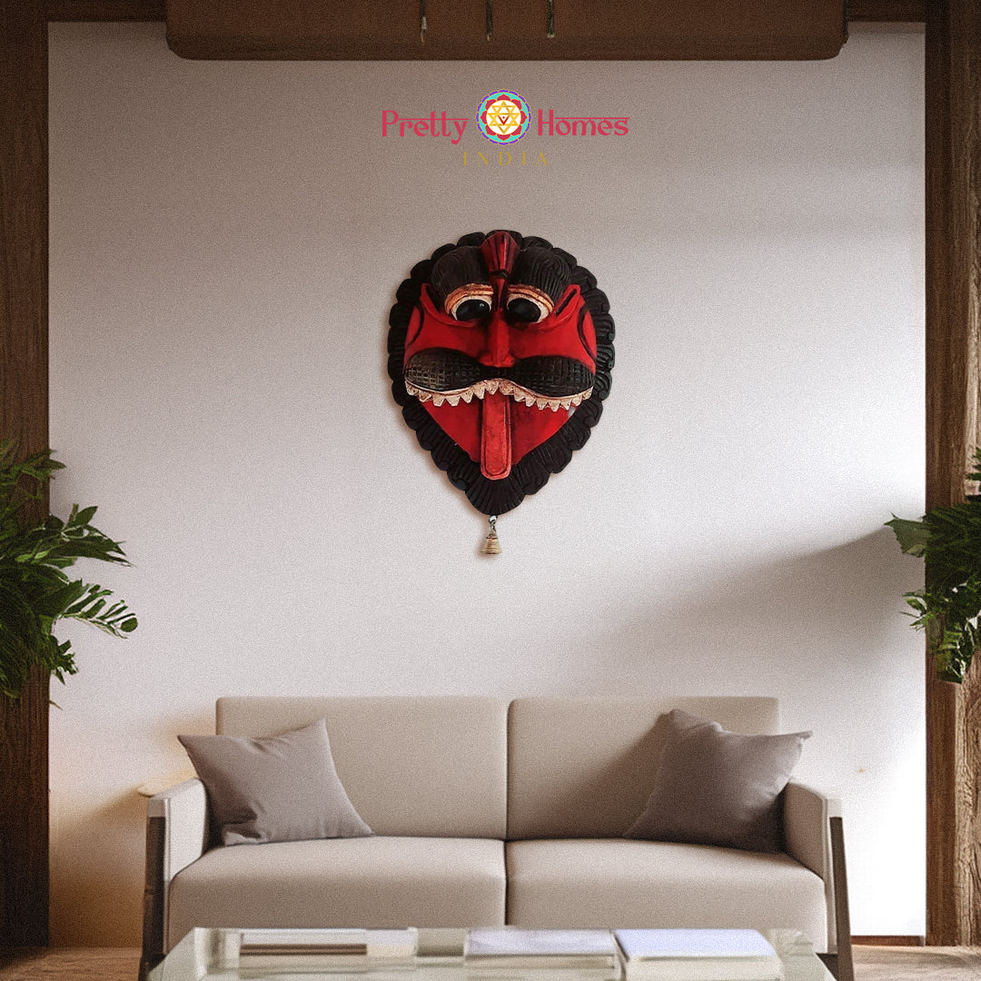 Hand-painted red carved wooden demon mask with hanging brass bell Indian wall decor.
