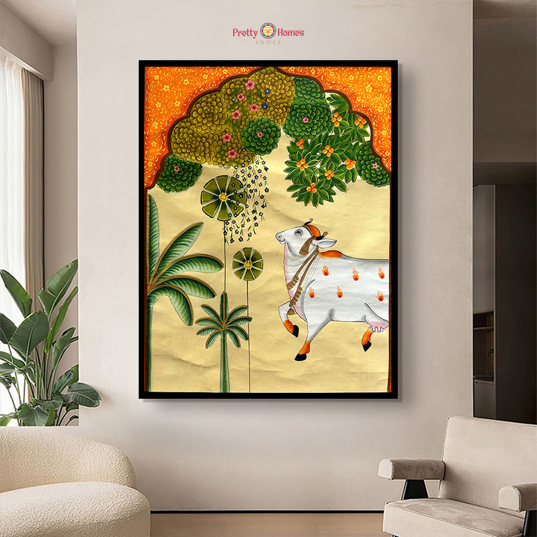 Handpainted Pichwai painting – cow under lush trees and jharokha arch in mustard background – Pretty Homes India.