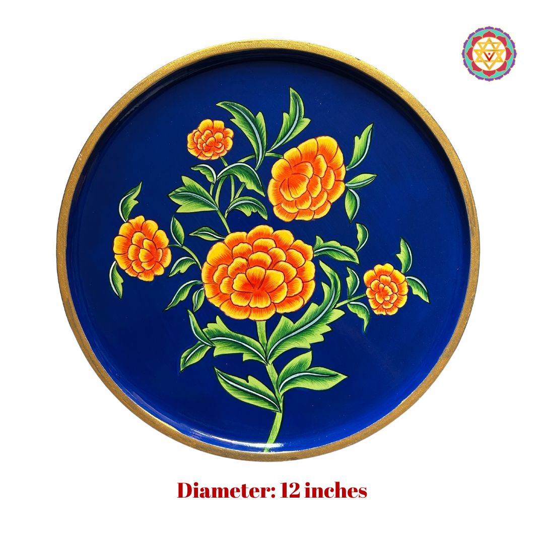 Handpainted marigold pichwai design plate with green leaves and orange blooms.