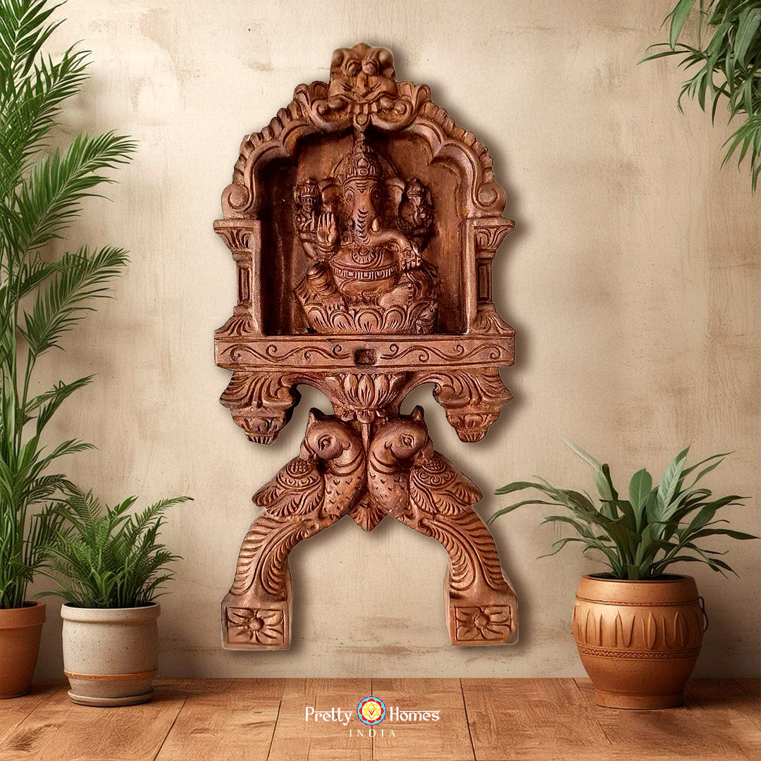 Woodcarved Ganesha & Laxmi kavadi style wall mounts with parrot carvings .